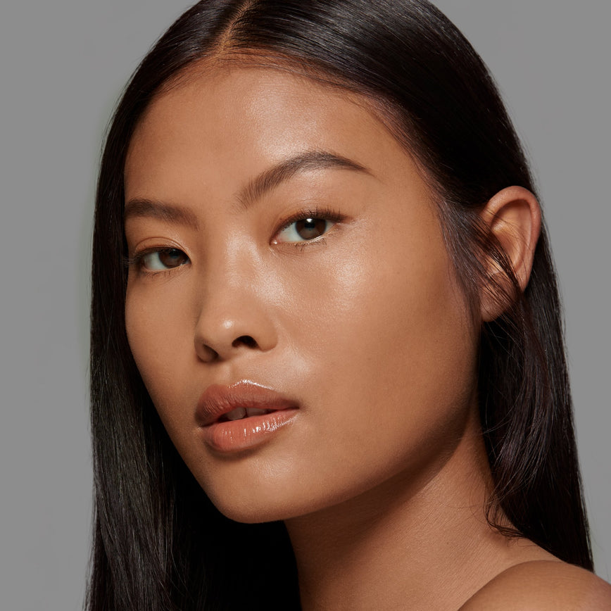Lisa Eldridge Seamless Skin Foundation Pictured on Model. The model has medium skin and neutral red undertones, brown eyes and straight black hair.