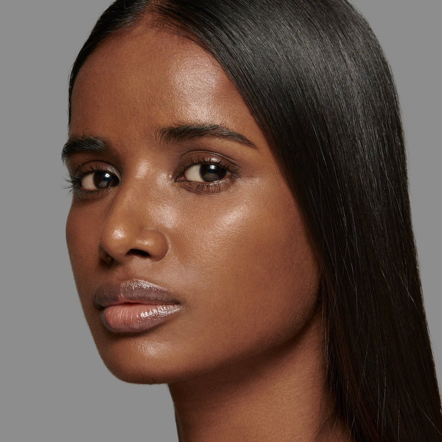 Lisa Eldridge Seamless Skin Foundation Pictured on Model. The model has medium/deep skin and neutral red undertones, brown eyes and straight black hair.