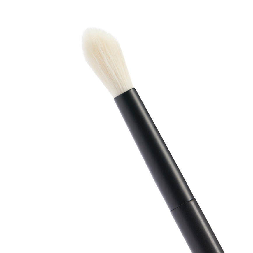Close up of the No. 8 Seamless Blend Brush. You can see the white bristles of the brush. It has a short, round tip.