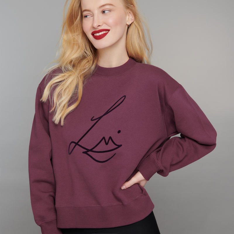 Lisa Eldridge Studio Sweatshirt in velvet midnight on a slim model. The sweatshirt has dropped shoulders and the Lisa Eldridge logo large on the front.